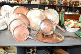 A set of late 19th / early 20th century copper pan lids with iron handles, various sizes, one lid