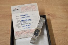 A vintage Tissot wristwatch, the rectangular dial having baton numerals on a stainless steel mesh
