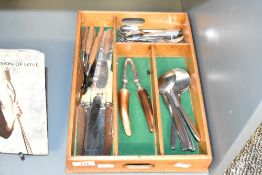 A vintage sectional cutlery tray, sold together with to a stainless steel and horn nut cracker,