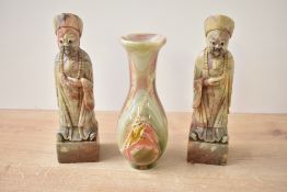 A pair of Chinese carved hard stone Confucius style figures, displayed on a square base seen