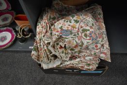 A box of floral print fabric in the manner of William Morris.