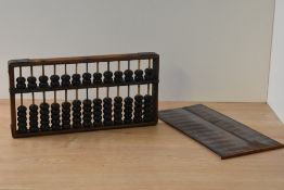 An early 20th century wooden bead abacus, possibly Japanese, 35cm.