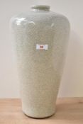 A large 20th century colossal style ceramic vase, decorated in crackle glaze on a cream ground,
