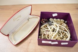 A collection of costume jewellery, including a boxed string of cream cultured pearls with a silver