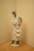 A large Lladro porcelain figure group number 4763, 'Obstetrician' Doctor with new born baby,