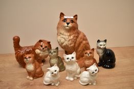 A selection of Beswick Pottery cat and kitten figures including seated Persian number 1867, kitten