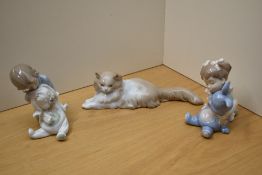 A group of three Nao by Lladro porcelain figures comprising 'Angora Cat' number 113, 'I Love You