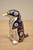 A Royal Crown Derby bone china Platapus paperweight having markings and gold coloured stopper to
