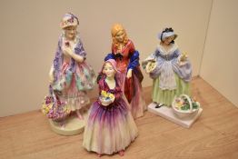 A group of four Royal Doulton bone china figurines comprising 'Spring Flowers' HN 1807 with hairline