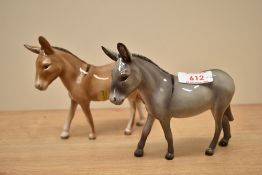 A pair of John Beswick pottery donkey's, in brown and grey gloss finish, both signed to the