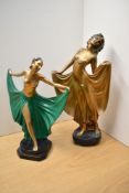 Two Art Deco style gilt and green painted figurines, both depicting women in long gowns/drapes. Both
