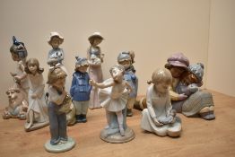 An assortment of Lladro and Nao by Lladro porcelian figurines comprising 'A Sweet Gesture' number