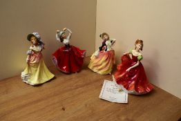 A group of four Royal Doulton figures comprising 'Autumn Breezes' HN 2131, 'Karen' HN 2388, '