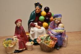 A group of three Royal Doulton bone china figurines comprising 'Curly Knob' HN 1627 (flowers