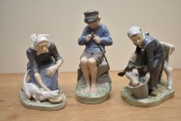 Three Royal Copenhagen figure groups comprising 'Women Feeding Cat' number 1012, 'Girl Feeding