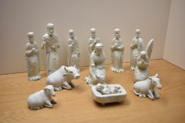 A thirteen piece carved white marble nativity scene to include the three wise men and three