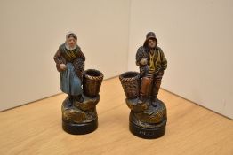 Two small vintage terracotta figures depicting both male and female fishermen, markings to front and
