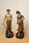 A pair of vintage Austrian Panked terracota figures depicting a shepherd and a lady feeding the