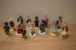 A collection of thirteen Royal Doulton bone china Bunnykins series figures including characters '