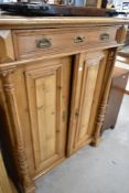 A Victorian pine cupboard having frieze drawer , height approx. 135cm