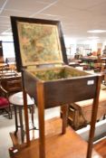 An early to mid 20th Century mahogany sewing table having lined interior