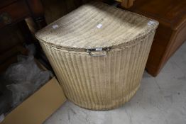 A vintage Lloyd Loom corner linen basket