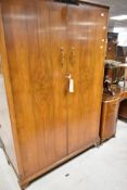 A vintage walnut three piece bedroom suite
