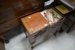 A vintage cantilever sewing box, and contents including cotton reels