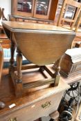 A traditional oak drop leaf occasional table