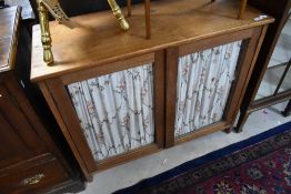 A vintage glazed cabinet base, with curtains to inner of doors, width approx. 94cm