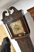 An 18th Century oak long cased clock having eight day movement with brass and silvered dial named
