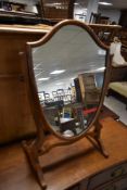 A mahogany toilet mirror , of shield form
