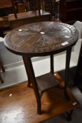 A traditional carved occasional tab;e having circular top and square undertier, diameter approx.
