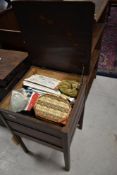 A vintage oak sewing box and contents, including patterns