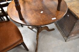 A 19th Century oak pedestal table having circular top on turned column and triple spay legs,