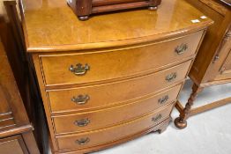 A reproduction yew wood bow front chest of four long drawers, approx. width 76cm, height 86cm
