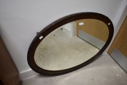 An early 20th Century mahogany oval wall mirror