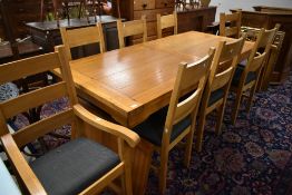 A good quality modern golden oak dining table and eight (six plus two) chairs, approx 200 x 90cm,