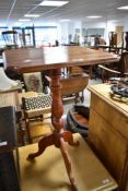 A 19th Century mahogany occasional table having shaped top with turned column and triple splay legs