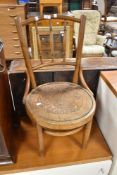 A late 19th or early 20th Century low seat bentwood chair