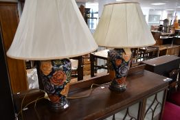 A pair of vintage style table lamps having tube lined style foliate decoration