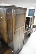 An early to mid 20th Century oak canted hall robe or wardrobe
