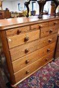 A 19th Century pitch pine chest of three shallow over two short and three long drawers, dimensions