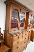 A Victorian oak bookcase over chest of three shallow, two short and three long drawers, dimensions