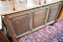 A period oak kist having carved frieze and three plain panels, width approx. 134cm