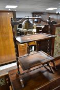 An early 20th Century oak folding cake stand having twist frame