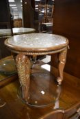 An Asian circular occasional table having bone inlay decoration , the triple legs having elephant