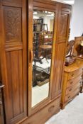 An early 20th Century mahogany mirror door wardrobe , having drawer base, width approx. 110cm