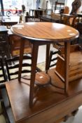 An Edwardian mahogany occasional table having circular top and undertier on square splay legs,