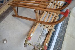 Two traditional wooden tobaggons/sledges
